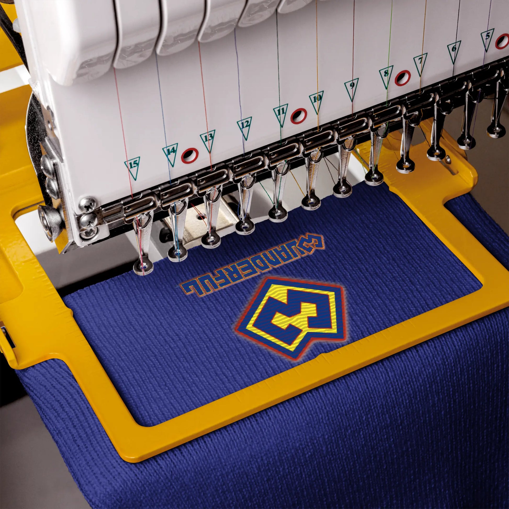 Embroidery machine adding a Wuanderful Locos superhero logo on a beanie